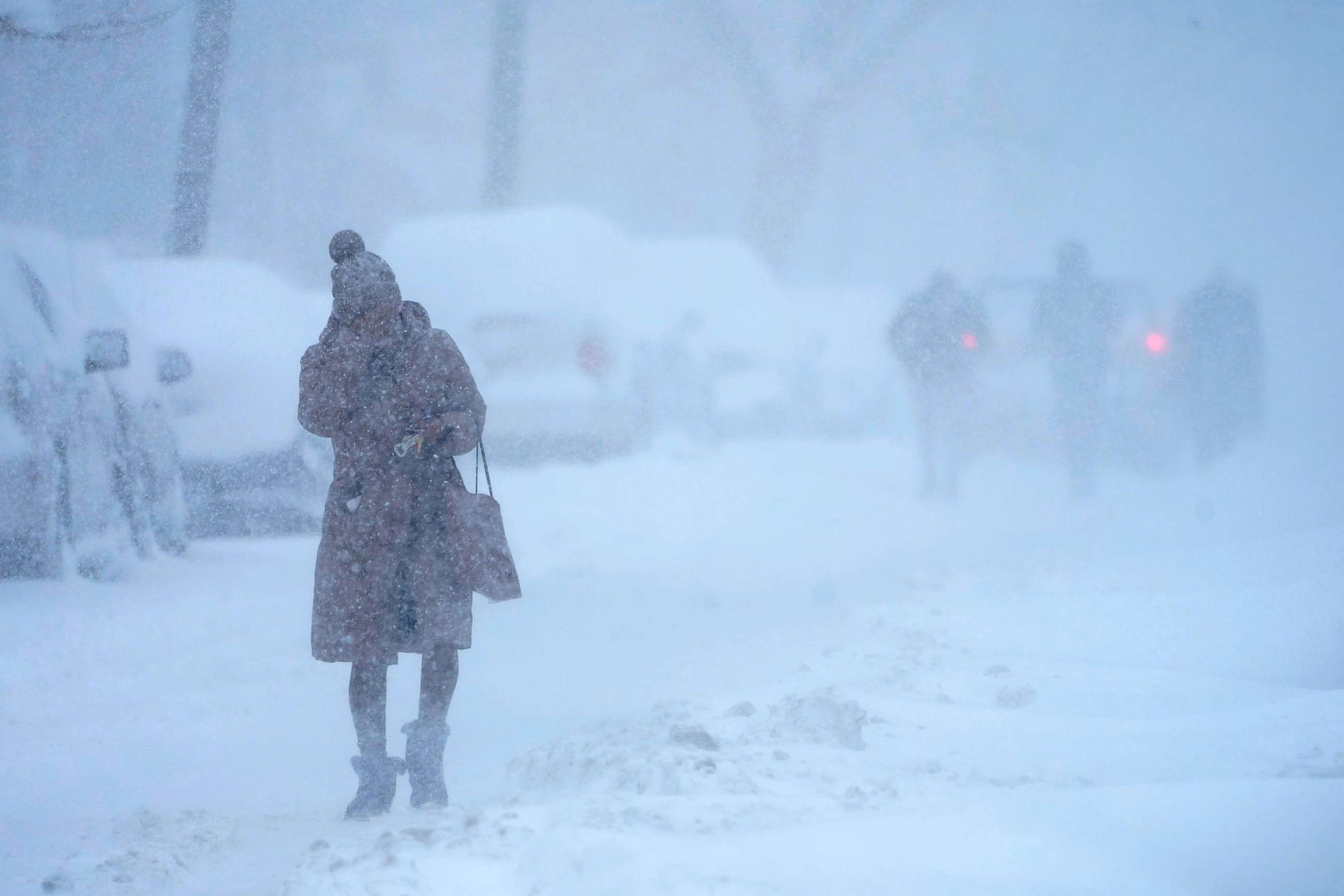 PHOTO: A woman tries to protect her face from blowing snow while walking in white-out conditions in Jersey City, N.J., Feb. 1, 2021.
