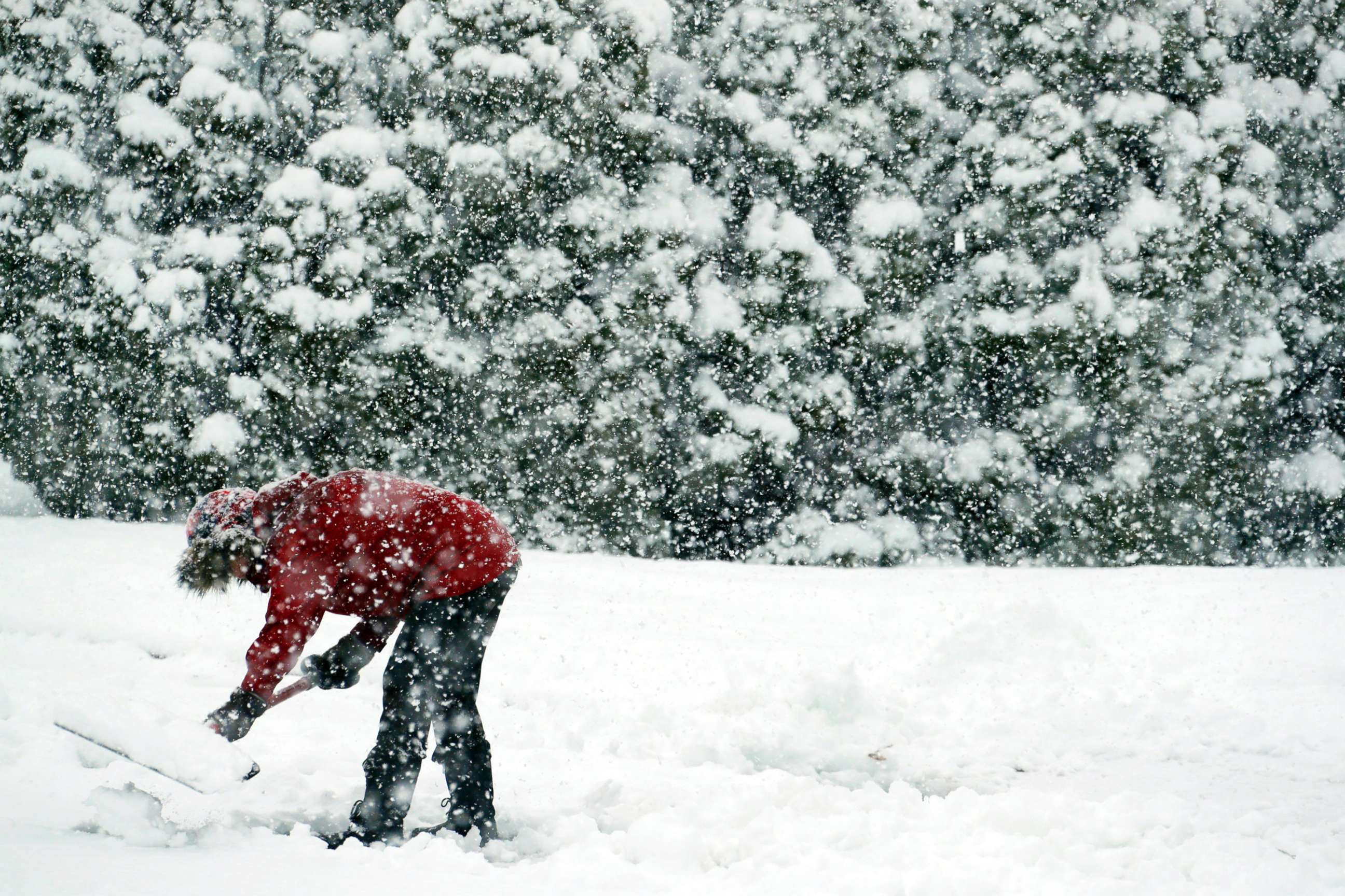 PHOTO: A woman shovels snow during a winter storm, March 7, 2018, in Springfield, Pa.