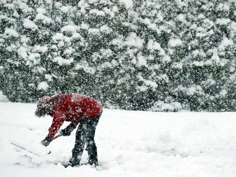PHOTO: A woman shovels snow during a winter storm, March 7, 2018, in Springfield, Pa.