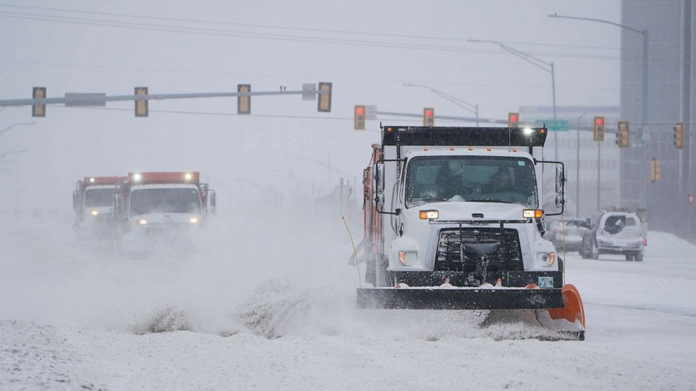 PHOTO: Snowplows works to clear the road during a winter storm Sunday, Feb. 14, 2021, in Oklahoma City. Snow and ice blanketed large swaths of the U.S. on Sunday, prompting canceled flights, making driving perilous and reaching into the Texas Gulf Coast.