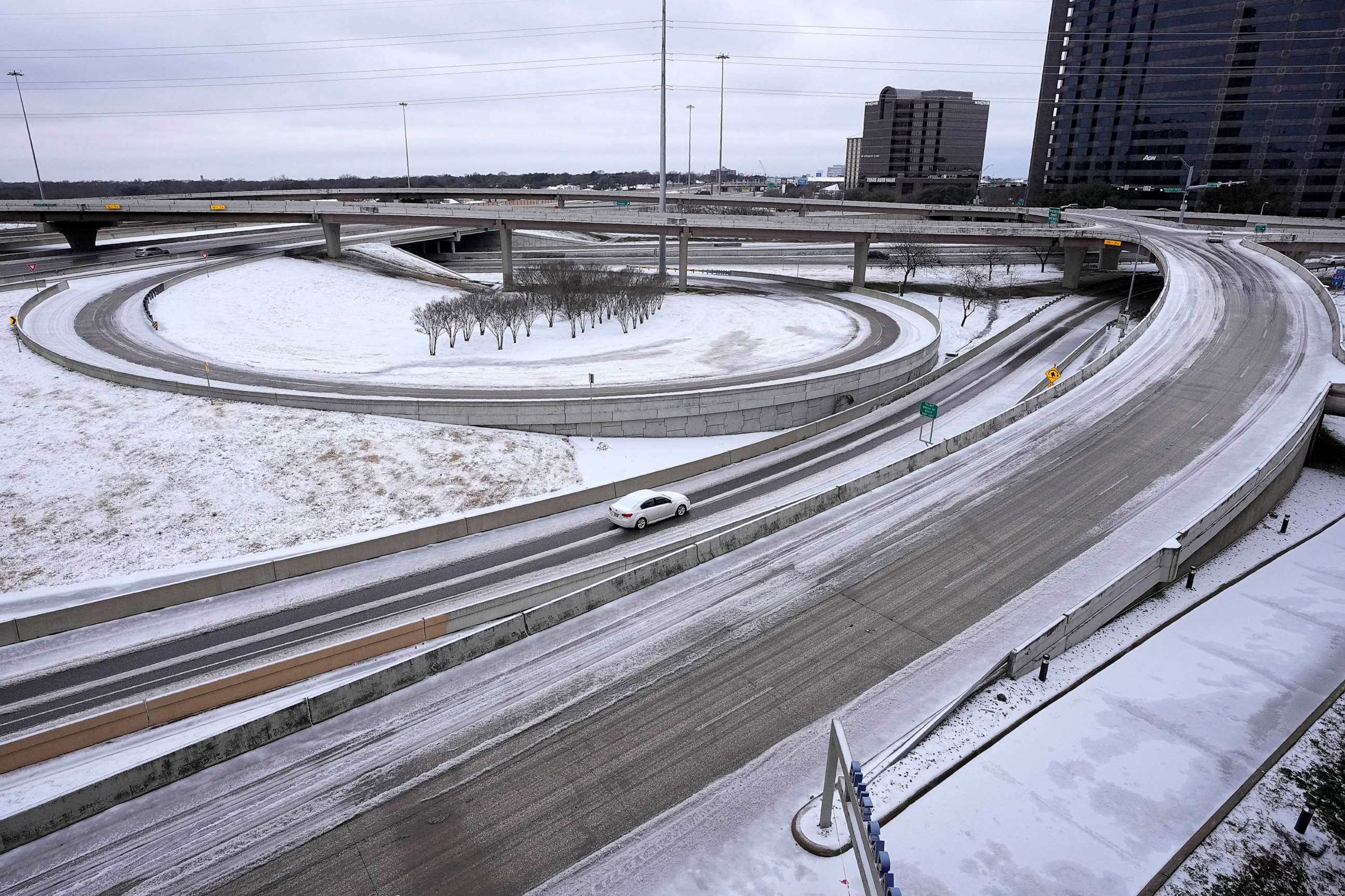 PHOTO: A lone driver makes their way through icy road conditions at the LBJ 635 Freeway and North Dallas Tollway interchange, Jan. 31, 2023, in Dallas.