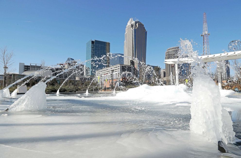PHOTO: Water squirts from a frozen fountain near downtown in Charlotte, N.C., on Jan. 2, 2018. 