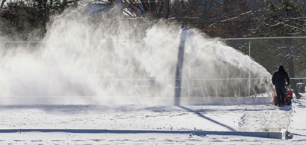 PHOTO: A town recreational employee clears snow from an outdoor skating rink in Burlington, Mass., Jan. 02  2018. 