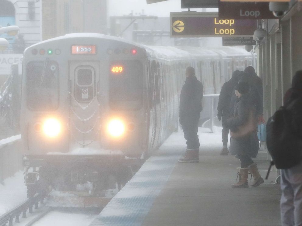 PHOTO: Snow is blown onto commuters while an arriving Chicago Transit Authority train arrives as a winter storm makes its way through several Midwest states, Feb. 9, 2018, in Chicago.