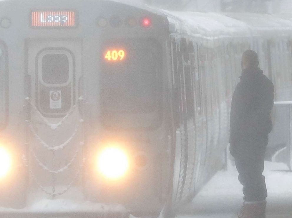 PHOTO: Snow is blown onto commuters while an arriving Chicago Transit Authority train arrives as a winter storm makes its way through several Midwest states, Feb. 9, 2018, in Chicago.