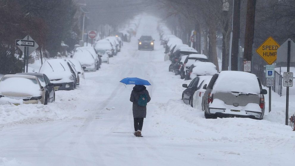 A man walks on a snowy road in New York, March 15, 2017.
