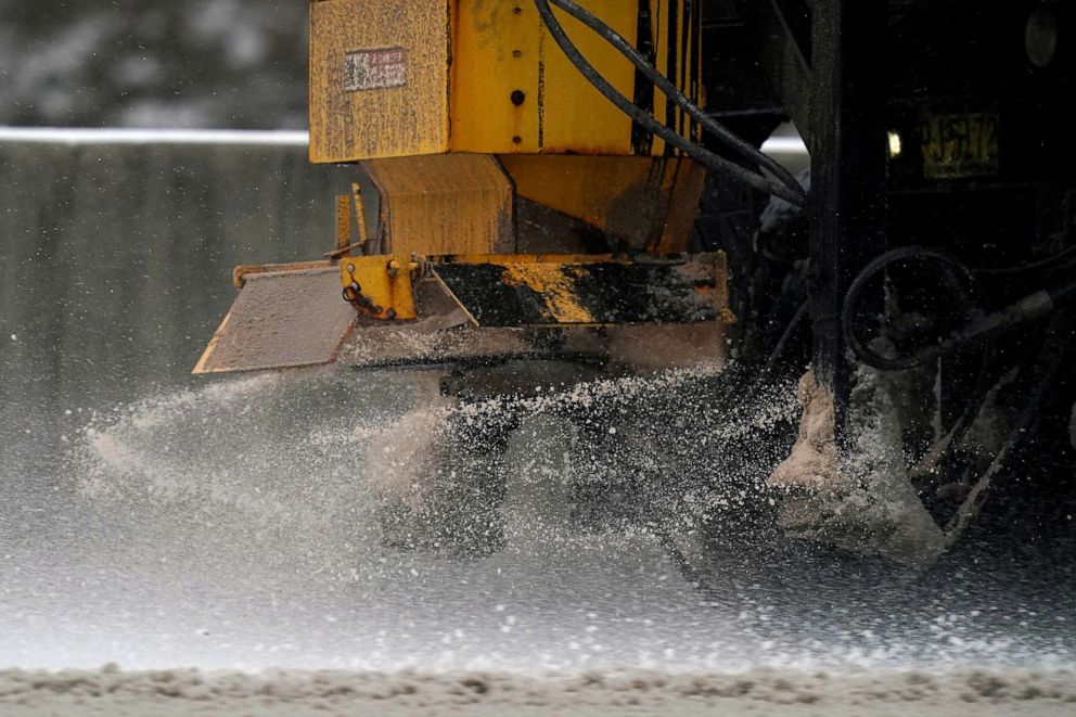PHOTO: A salt truck spreads brine on the road as a winter storm moves through the area near Durham, N.C., Jan. 16, 2022.