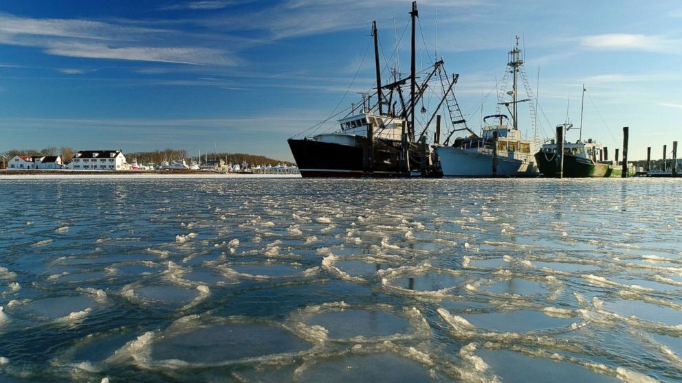PHOTO: Fishing trawlers sit on the frozen harbor of Lake Montauk surrounded by thin sheets of ice, Jan. 7, 2018, in Montauk, N.Y. 