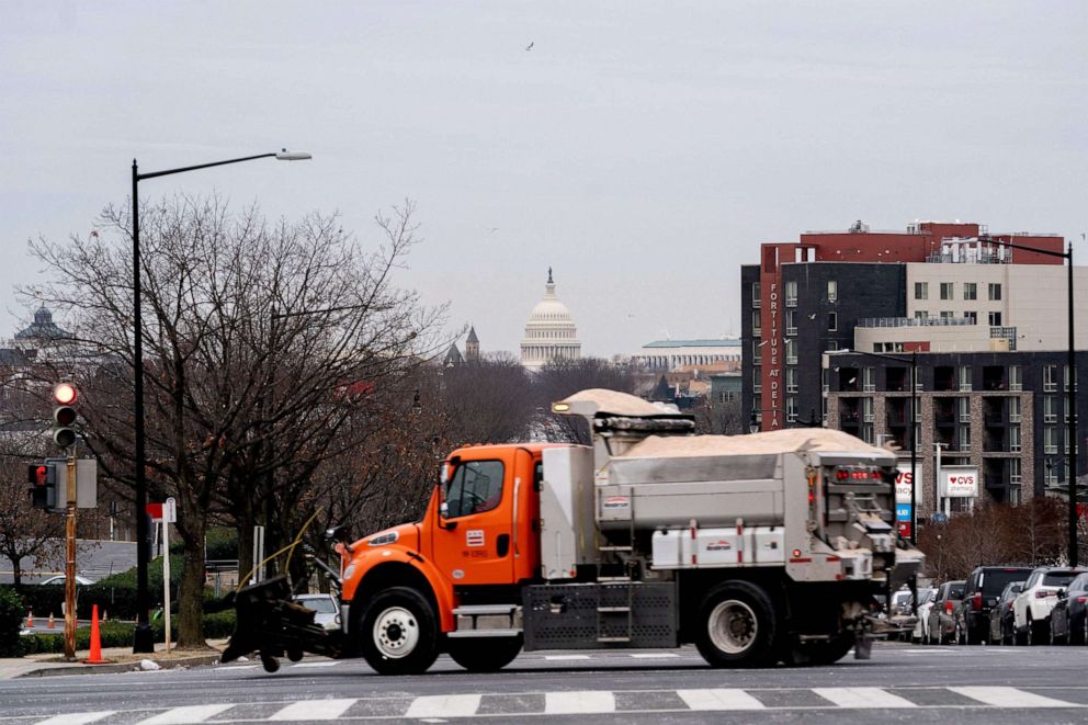 PHOTO: The US Capitol is seen past a snowplow in Washington, DC, on Jan. 16, 2022, as the city prepares for a winter storm.