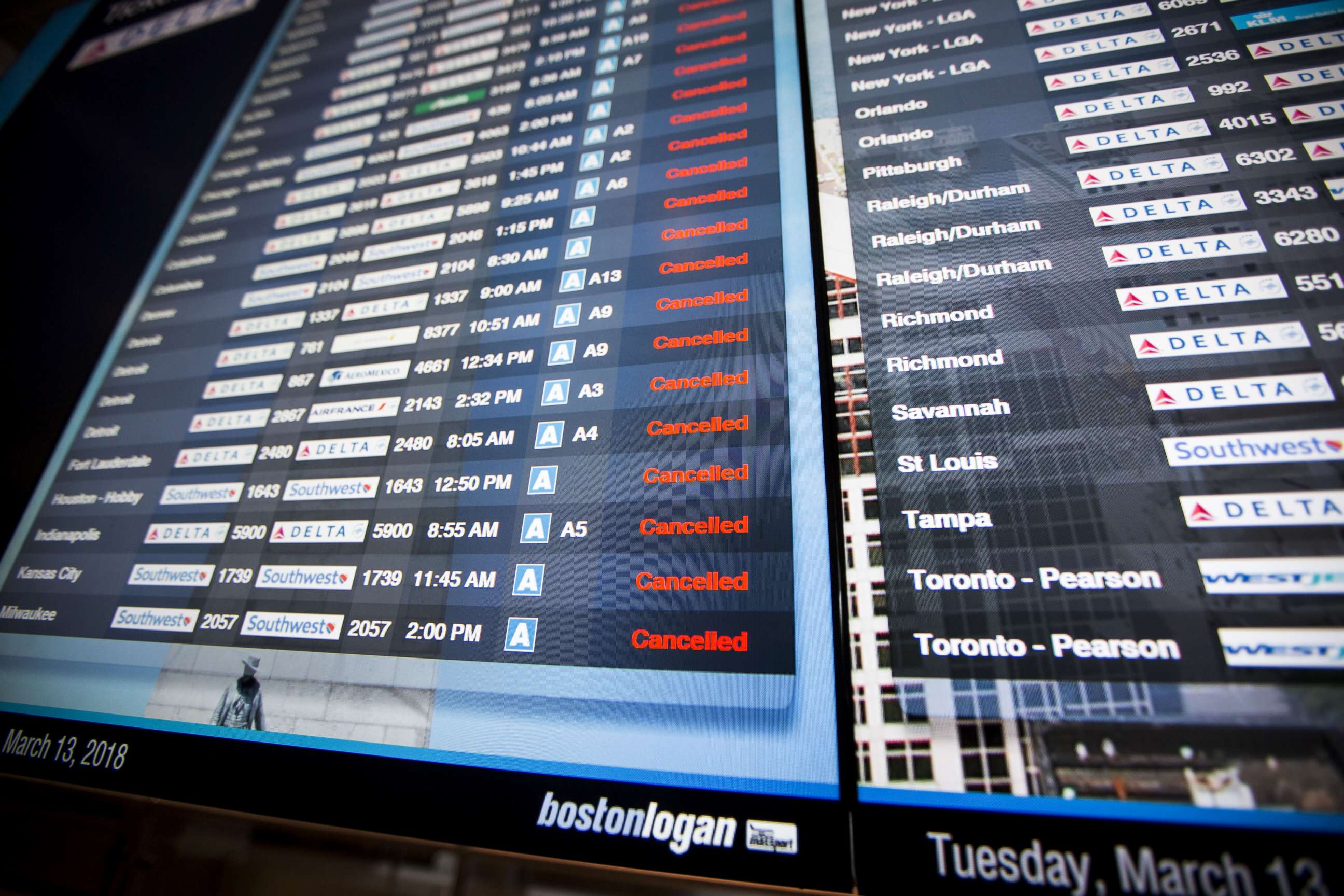PHOTO: Information boards at Logan International Airport show hundreds of cancelled flights as a winter storm bears down, March 13, 2018, in Boston.