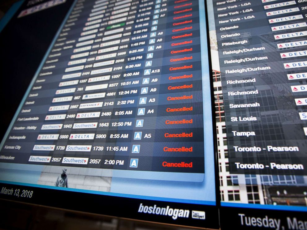 PHOTO: Information boards at Logan International Airport show hundreds of cancelled flights as a winter storm bears down, March 13, 2018, in Boston.