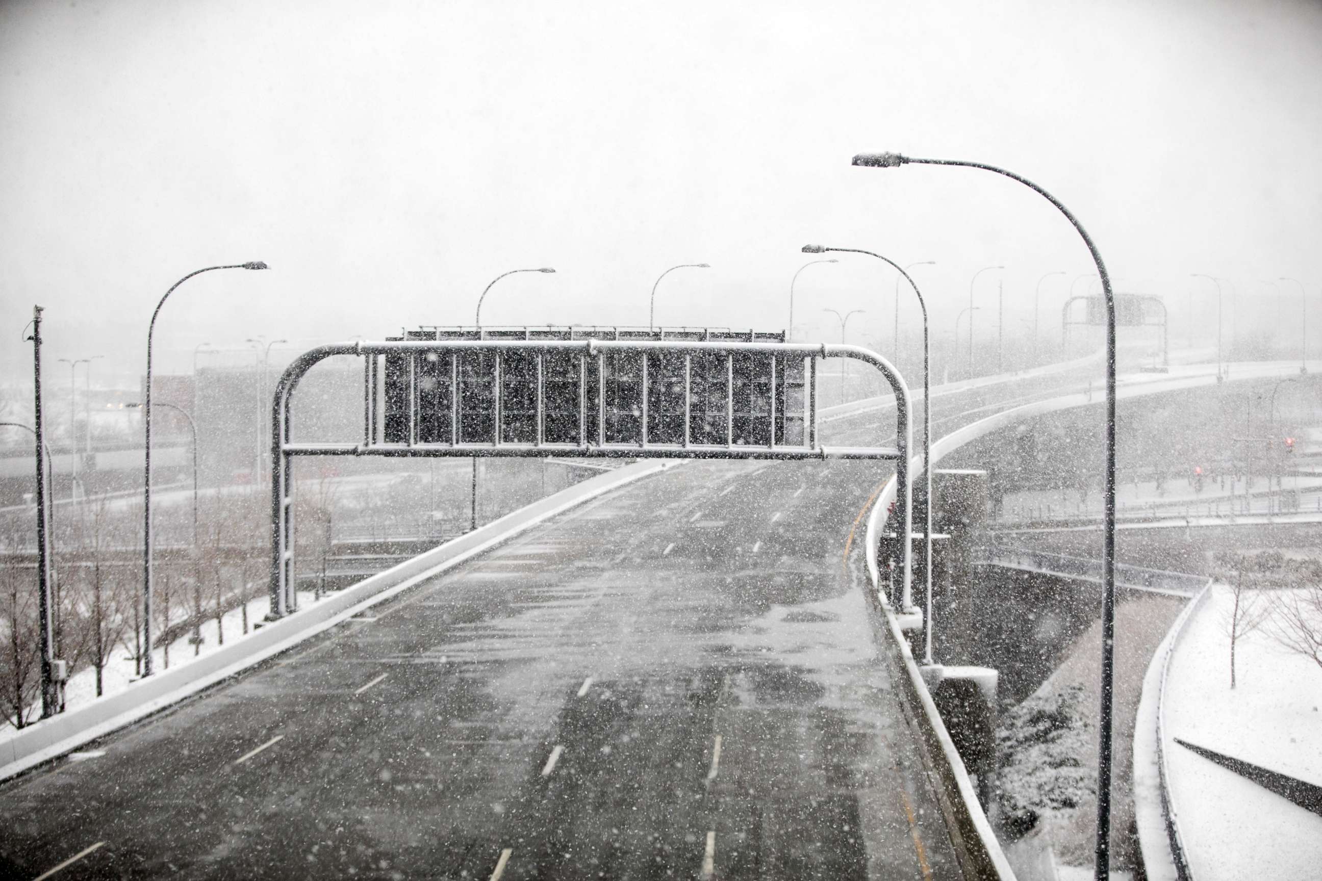 PHOTO: The road into Logan International Airport is empty as a winter storm bears down, March 13, 2018, in Boston.