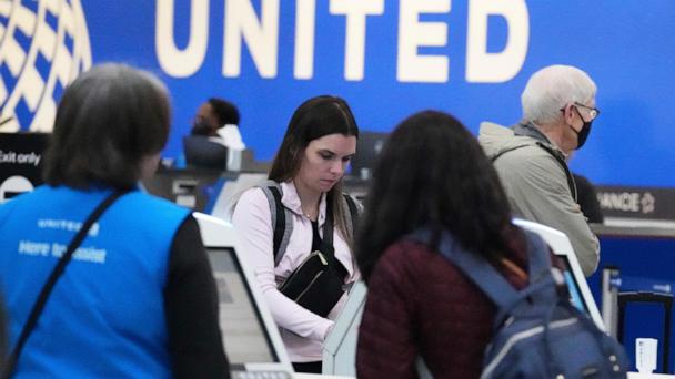 Travelers print their boarding passes at kiosks inside of O'Hare International Airport in Chicago, Friday, May 23, 2025. (AP Photo/Nam Y. Huh)