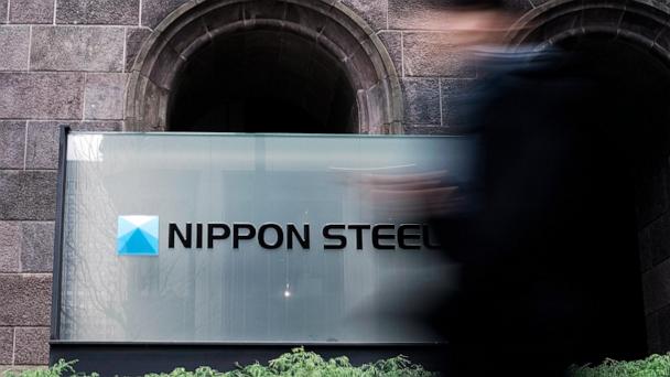 FILE - A person walks past a Nippon Steel Corporation sign at the company headquarters on Jan. 7, 2025, in Tokyo. (AP Photo/Eugene Hoshiko, File)