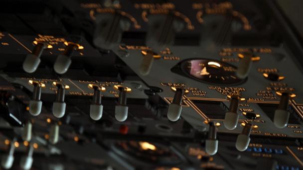 Switches in the cockpit of a United Airlines flight simulator are lit up at the company's training campus in Denver, Friday, May 16, 2025. (AP Photo/Thomas Peipert)