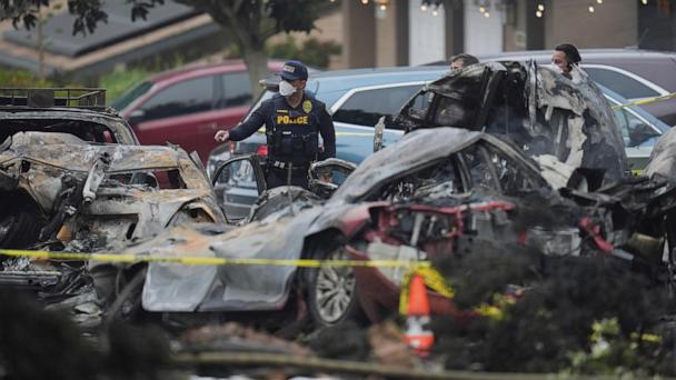 Authorities work the scene where a small plane crashed into a San Diego neighborhood, setting several homes on fire and forcing evacuations along several blocks early Thursday, May 22, 2025. (AP Photo/Gregory Bull)
