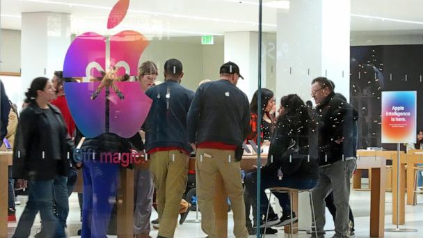 FILE - Shoppers look at Apple products in the Apple Store at the Walden Galleria in Buffalo, NY, on Saturday, Nov. 30, 2024. (AP Photo/Gene J. Puskar, File)