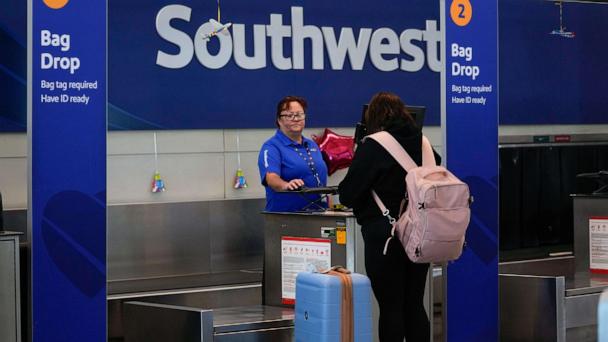 FILE - A Southwest Airlines traveler checks a bag at Midway International Airport, Tuesday, March 11, 2025, in Chicago. (AP Photo/Erin Hooley, File)