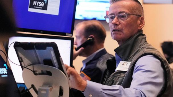 Trader Neil Catania works on the floor of the New York Stock Exchange, Tuesday, July 1, 2025. (AP Photo/Richard Drew)