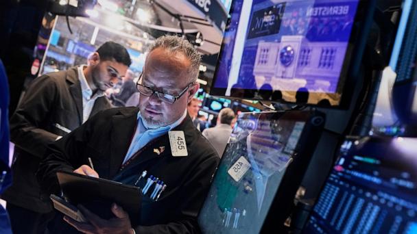 Trader Robert Arciero, right, works on the floor of the New York Stock Exchange, Tuesday, May 27, 2025. (AP Photo/Richard Drew)