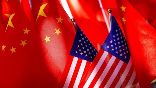 FILE - American flags are displayed together with Chinese flags on top of a trishaw on Sept. 16, 2018, in Beijing. (AP Photo/Andy Wong, File)