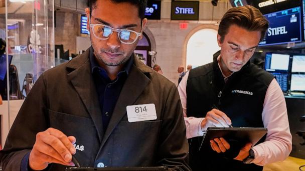 Trader Niall Pawa, left, works with a colleague on the floor of the New York Stock Exchange, Tuesday, July 1, 2025. (AP Photo/Richard Drew)