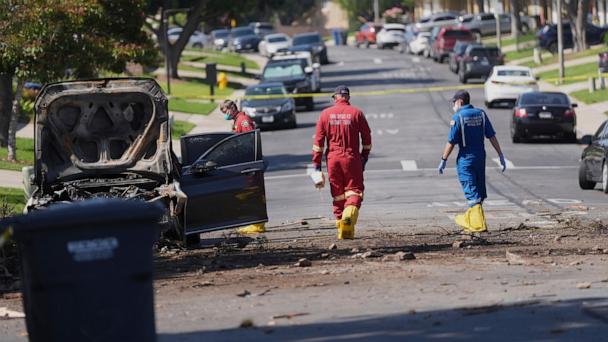 Authorities work the scene where a small plane crashed into a San Diego neighborhood, setting several homes on fire and forcing evacuations along several blocks early Thursday, May 22, 2025. (AP Photo/Gregory Bull)