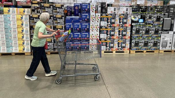 A shopper surveys goods on display in a Costco warehouse Wednesday, May 21, 2025, in Lone Tree, Colo. (AP Photo/David Zalubowski)