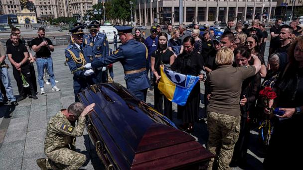 A Ukrainian serviceman says goodbye to Ukrainian F-16 pilot Maksym Ustymenko, during a farewell ceremony in Kyiv, Ukraine, on Thursday, July 3, 2025. (AP Photo/Evgeniy Maloletka)