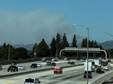 Fast-growing brush fire in Southern California threatens homes