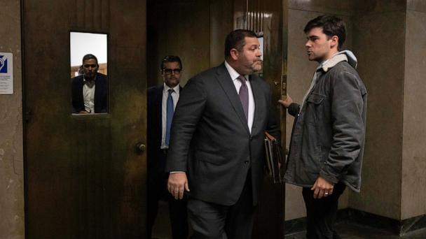 Wayne Gosnell, center, attorney for John Woeltz, cryptocurrency investor charged for kidnapping and false imprisonment, exits a courtroom, Wednesday, May 28, 2025, in New York. (AP Photo/Yuki Iwamura)