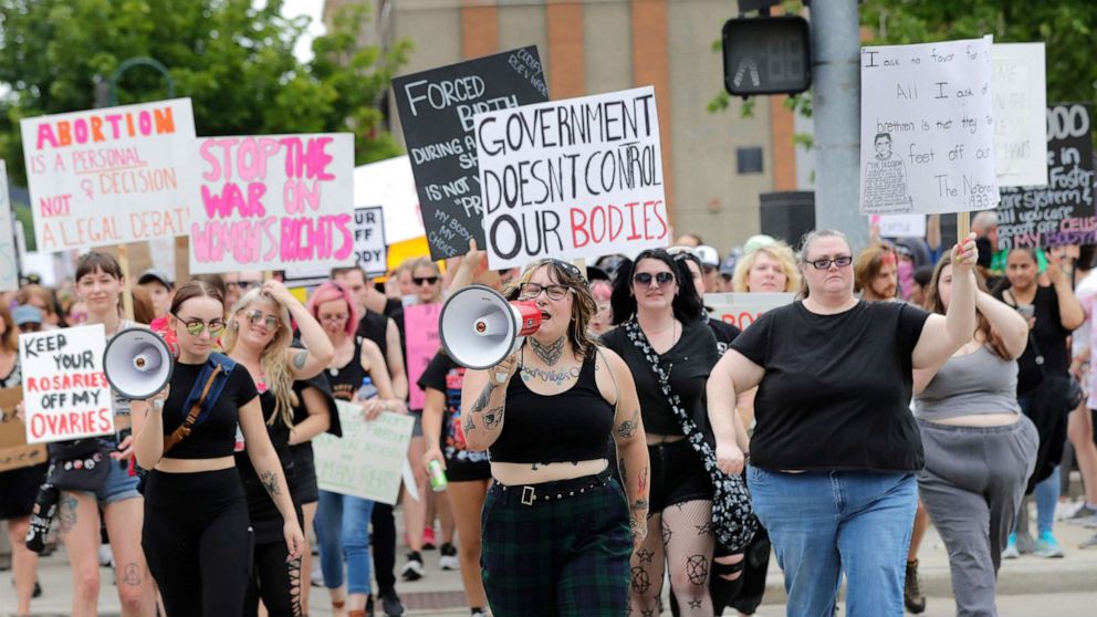PHOTO: Audrey Umnus, center, leads a march along College Avenue to protest the overturning of Roe v. Wade, July 4, 2022, in Appleton, Wis.