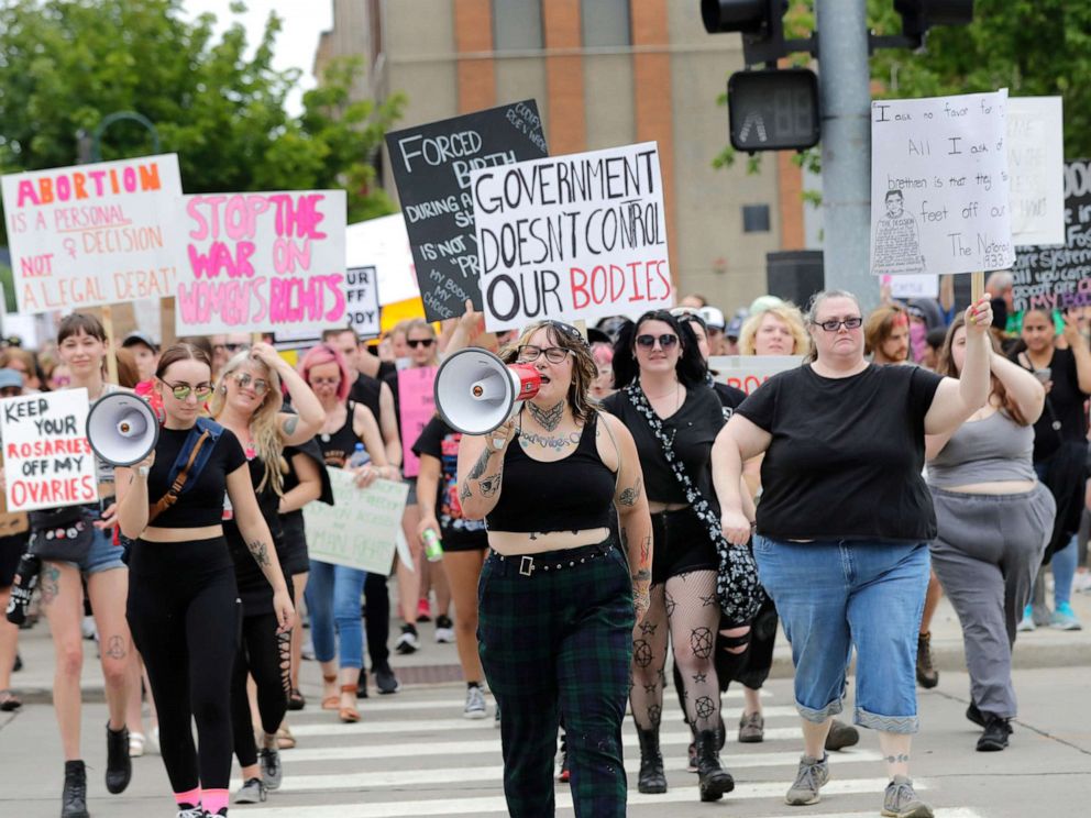 PHOTO: Audrey Umnus, center, leads a march along College Avenue to protest the overturning of Roe v. Wade, July 4, 2022, in Appleton, Wis.