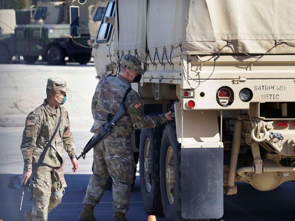 PHOTO: National Guard troops check their equipment at at Wisconsin State Fair Park on Oct. 7, 2020.