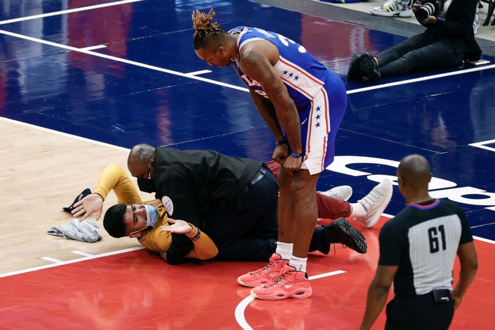 PHOTO: Dwight Howard of the Philadelphia 76ers looks down at a fan who ran onto the court and was tackled by security during Game Four of the Eastern Conference first round series against the Washington Wizards, May 31, 2021, in Washington, D.C.