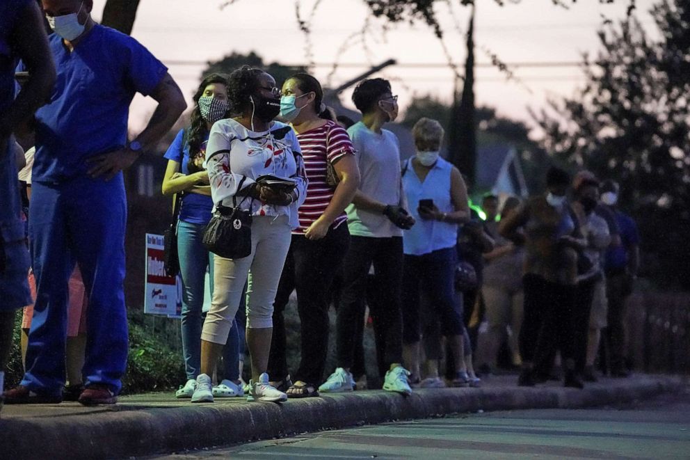 PHOTO: People wait in line to cast their ballots for the upcoming presidential election as early voting begins in Houston, Oct. 13, 2020.