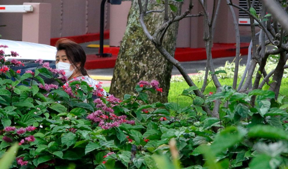 PHOTO: A woman wears a mask in Honolulu, Hawaii, as state officials announce more restrictions in response to a pandemic of the novel coronavirus, March 23, 2020.