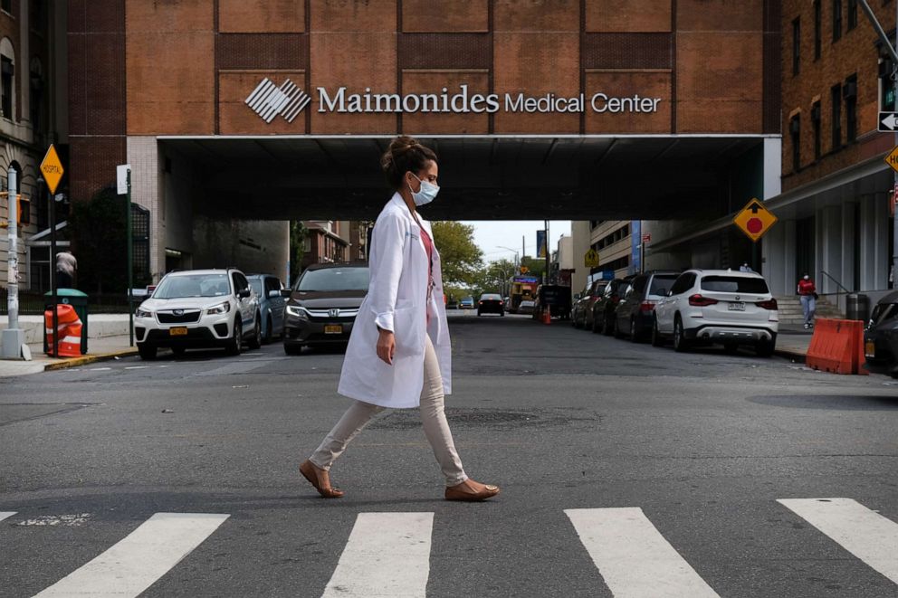 PHOTO: A medical worker walks by the Maimonides Medical Center in a neighborhood that saw a significant number of COVID-19 cases early on in the pandemic on Sept. 14, 2020, in the Brooklyn borough of New York City. 