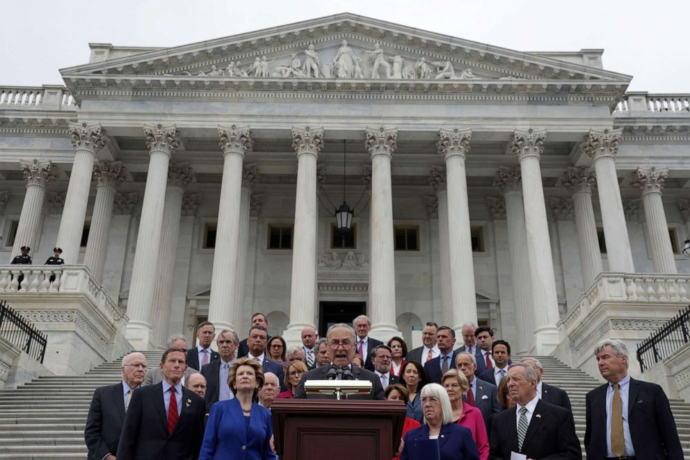 PHOTO: Senate Majority Leader Sen. Chuck Schumer speaks about the leaked Supreme Court draft decision to overturn Roe v. Wade as Democratic Senate members listen on the steps of the Supreme Court, May 3, 2022.