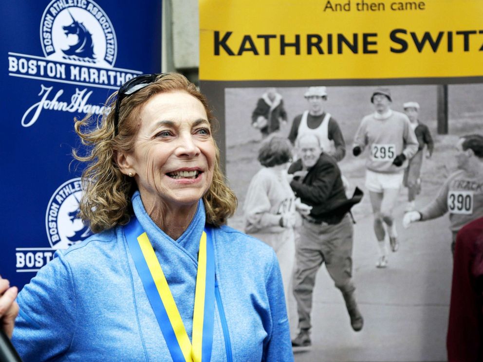 PHOTO: Kathrine Switzer, the first official woman entrant in the Boston Marathon in 1967, smiles while standing in front of an image of herself being harassed while competing in that race during a news conference in Boston, April 18, 2017. 