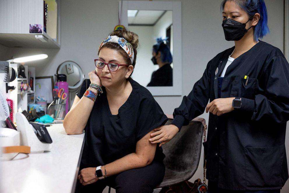 PHOTO: Houston Women's Reproductive Services staff Catalina Leona and Terri Chen watch a live stream of President Joe Biden delivering a speech before signing an executive order in Houston, Texas, July 8, 2022.