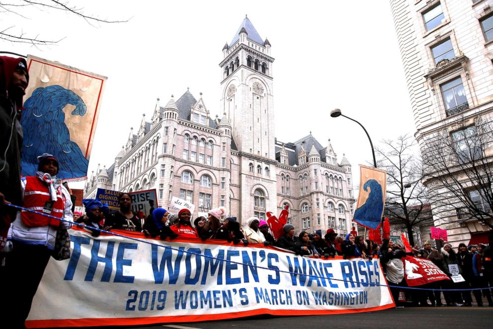 PHOTO: Demonstrators march past the Trump International Hotel during the third annual Women's March at Freedom Plaza in Washington, Jan. 19, 2019. 