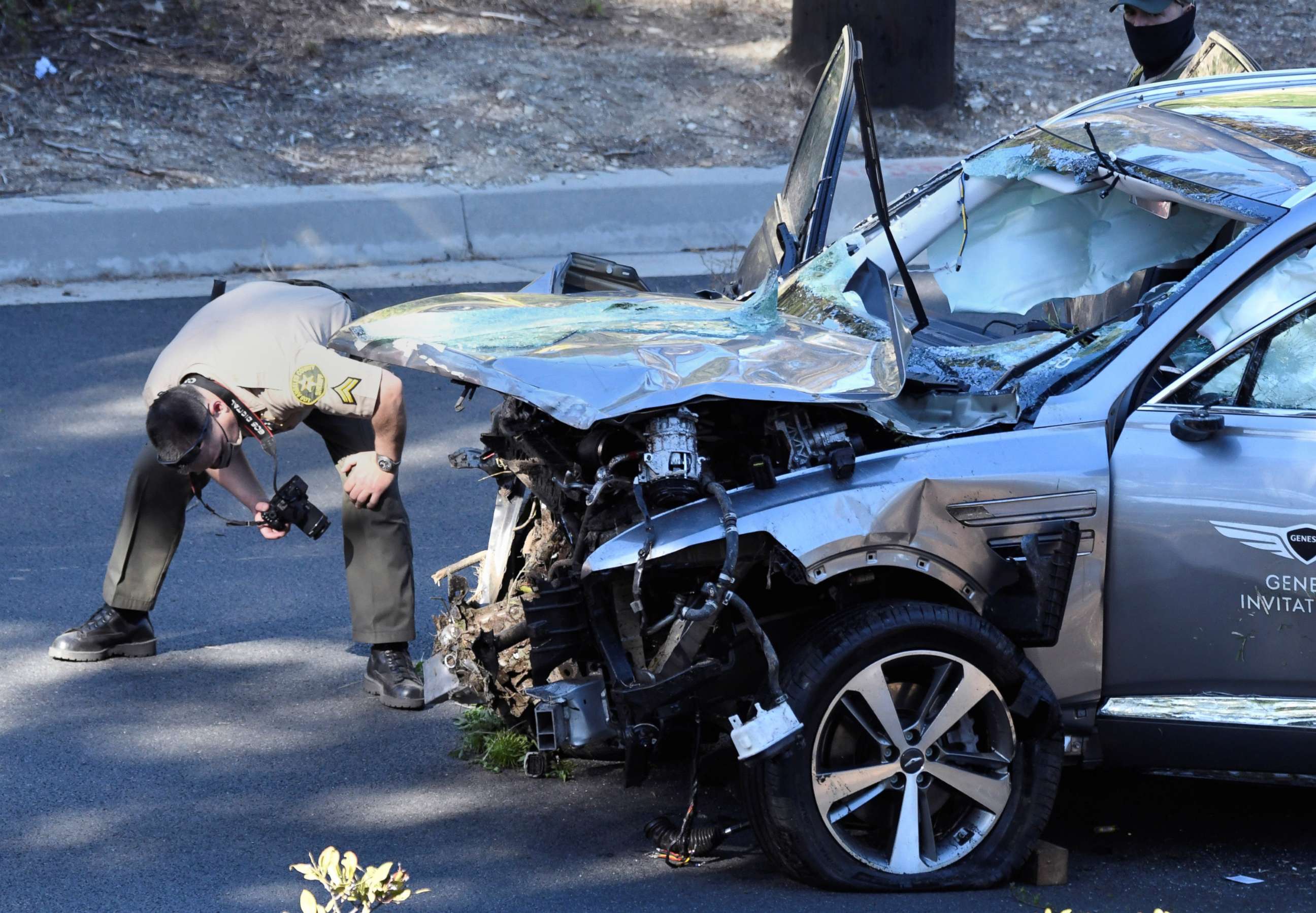 PHOTO: Los Angeles County Sheriff's Deputies inspect the vehicle of golfer Tiger Woods after it was involved in a single-vehicle accident in Los Angeles, Feb. 23, 2021.