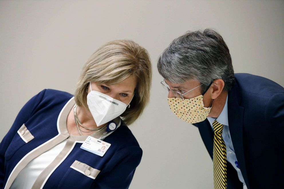 PHOTO: Dr. LouAnn Woodward, vice chancellor for health affairs and dean of the school of medicine, left, discusses concerns with the state's spike in COVID-19 patients at hospitals across the state on Thursday, July 9, 2020, in Jackson, Miss.