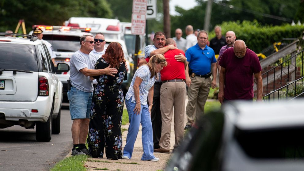 PHOTO: Community members and family console one another after two workers were found dead in a sewer manhole in Alden, Pa., July 11, 2019.