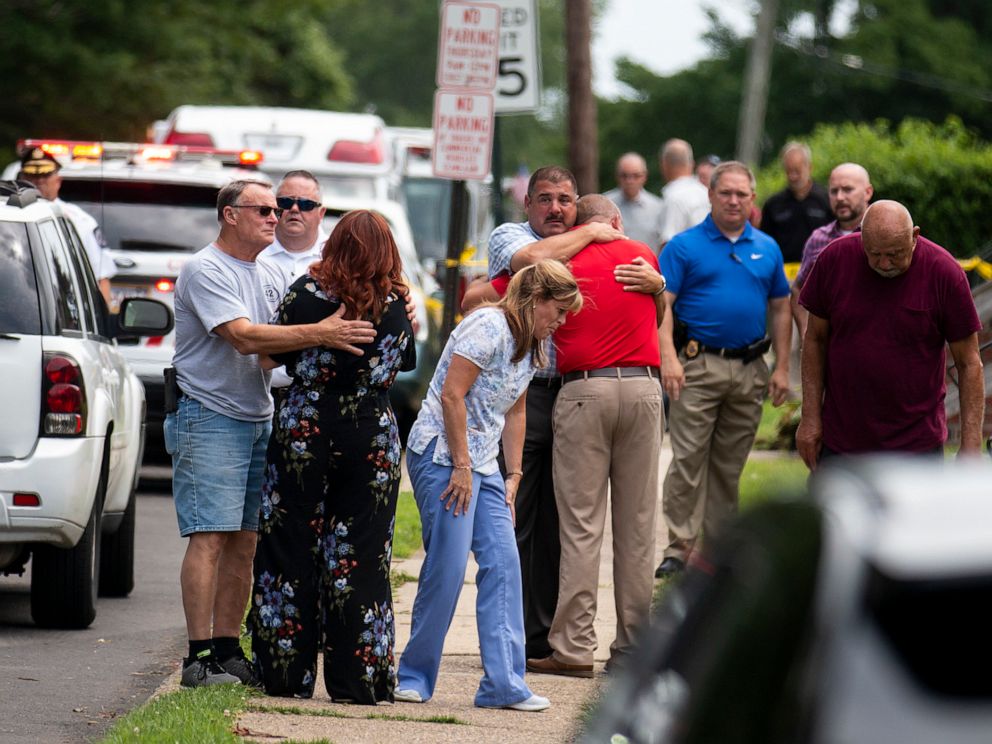 PHOTO: Community members and family console one another after two workers were found dead in a sewer manhole in Alden, Pa., July 11, 2019.