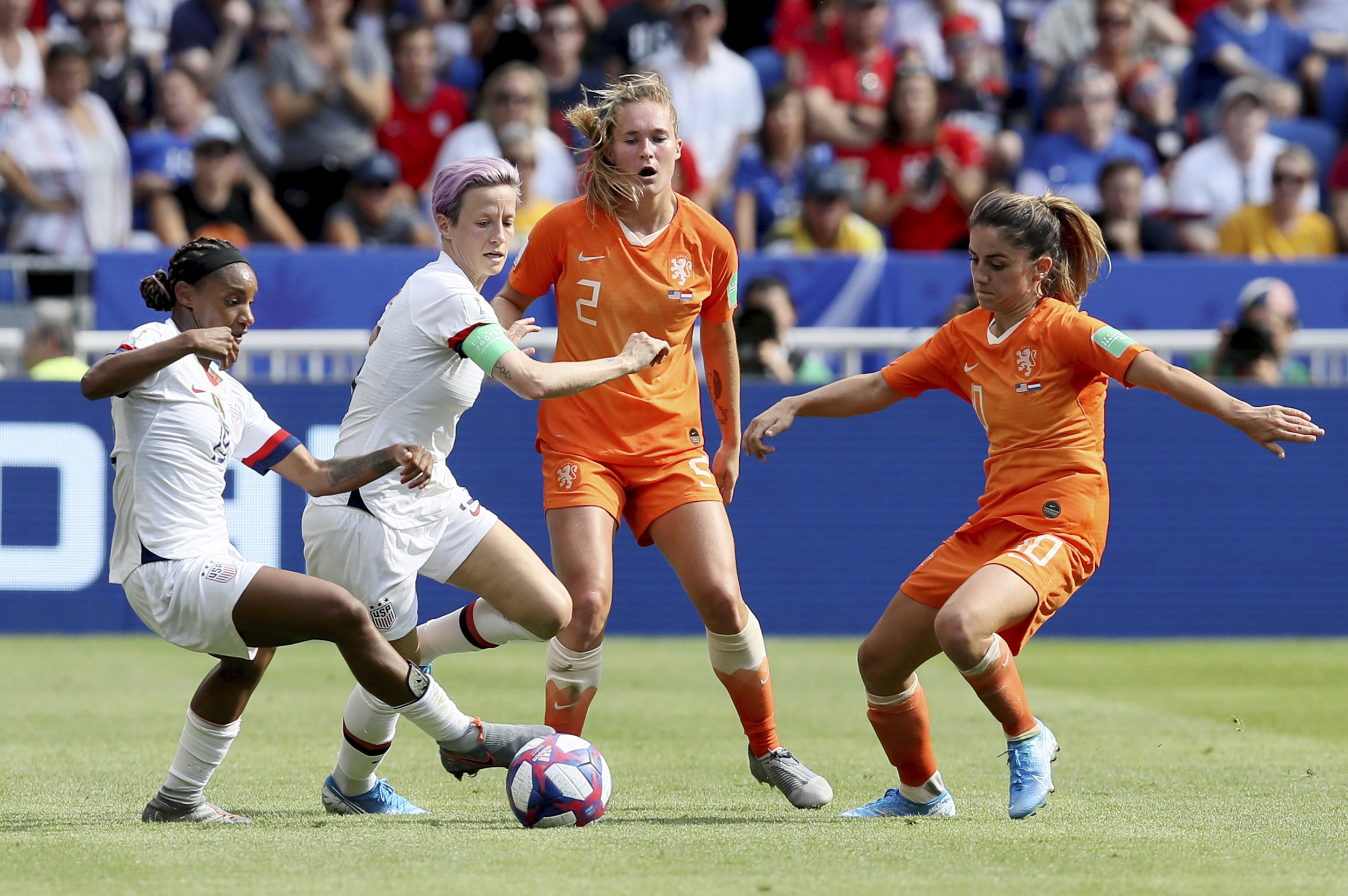 PHOTO: Crystal Dunn and  Megan Rapinoe, center left, fights for the ball with Netherlands' Desiree Van Lunteren,  and Netherlands' Danielle Van De Donk during the Women's World Cup final soccer match in Decines, outside Lyon, France, July 7, 2019.