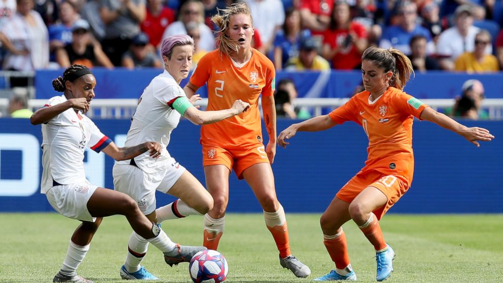 PHOTO: Crystal Dunn and  Megan Rapinoe, center left, fights for the ball with Netherlands' Desiree Van Lunteren,  and Netherlands' Danielle Van De Donk during the Women's World Cup final soccer match in Decines, outside Lyon, France, July 7, 2019.