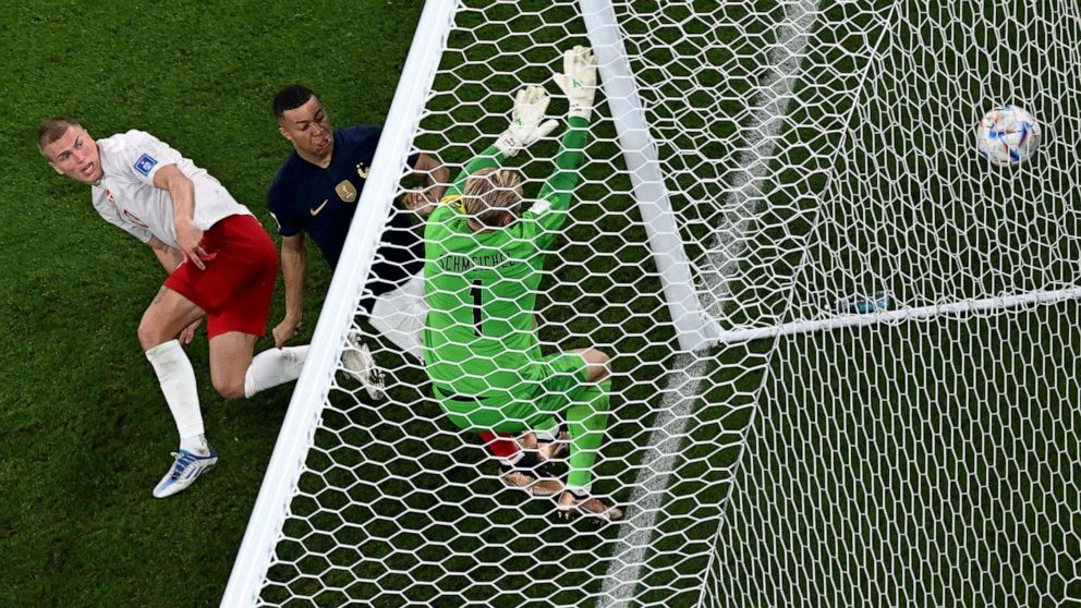 PHOTO: France's forward #10 Kylian Mbappe scores his team's second goal in front of Denmark's goalkeeper #01 Kasper Schmeichel during the Qatar 2022 World Cup match between France and Denmark at Stadium 974, in Doha, Qatar, on Nov. 26, 2022.