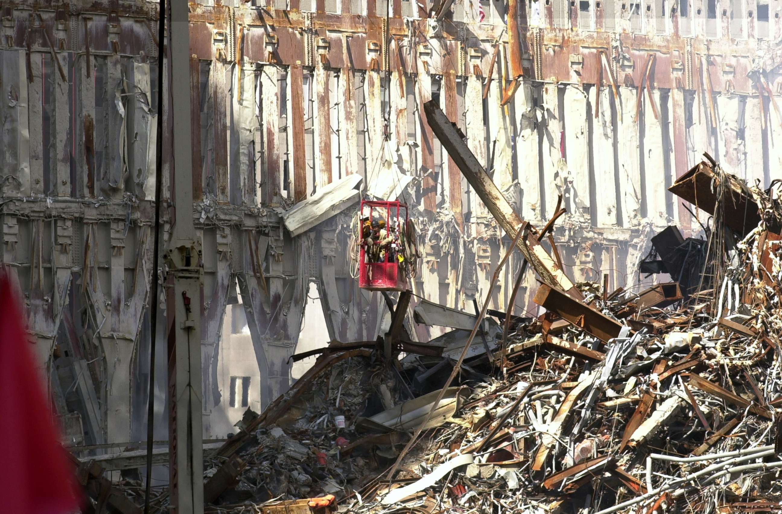 PHOTO: Workers at Ground Zero are suspended over a mountain of rubble as they dismantle the skeletal remains of Tower 2, all that still stands after the Sept. 11 terrorist attack on the World Trade Center, Sept. 27, 2001, in New York.